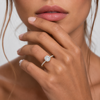 Close-up of a hand wearing a diamond ring with a blurred background