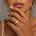 Close-up of a hand wearing a diamond ring with a neutral background