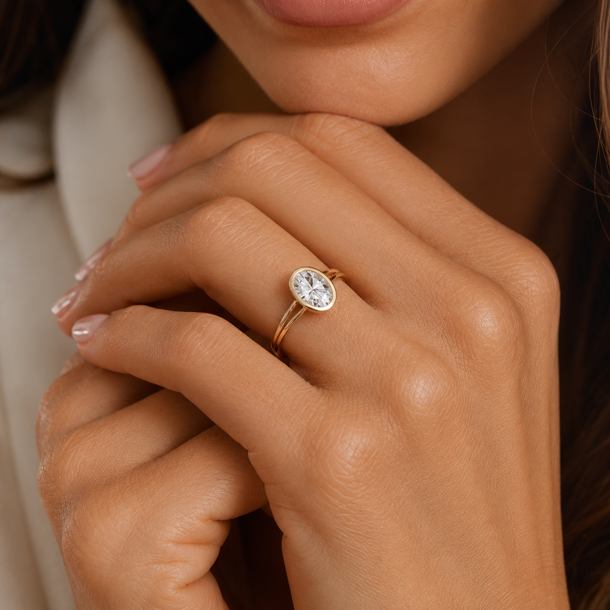 Close-up of a hand wearing a diamond ring with a blurred background