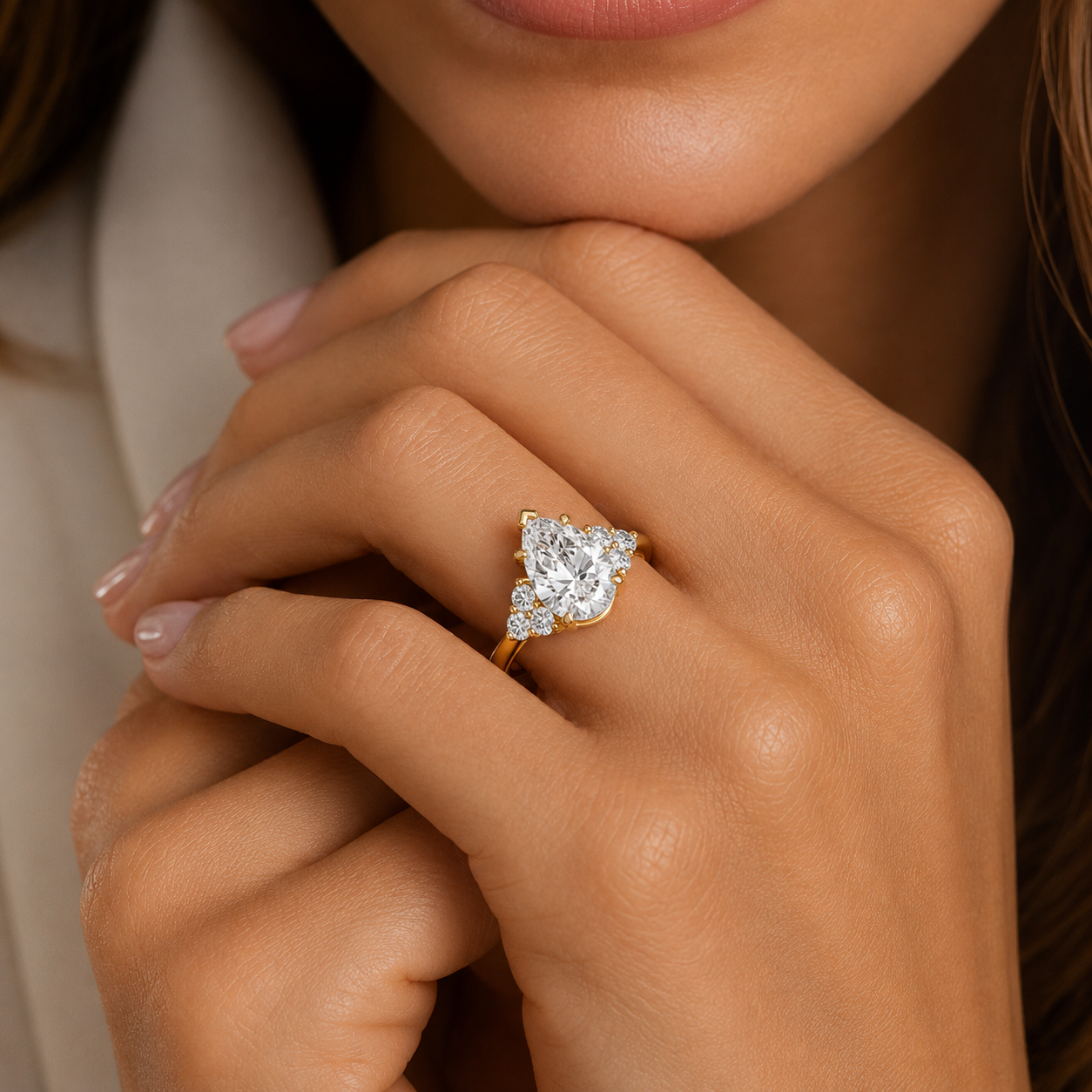 Close-up of a hand wearing a diamond ring with a soft focus background