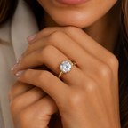 Close-up of a hand wearing a diamond ring with a blurred background