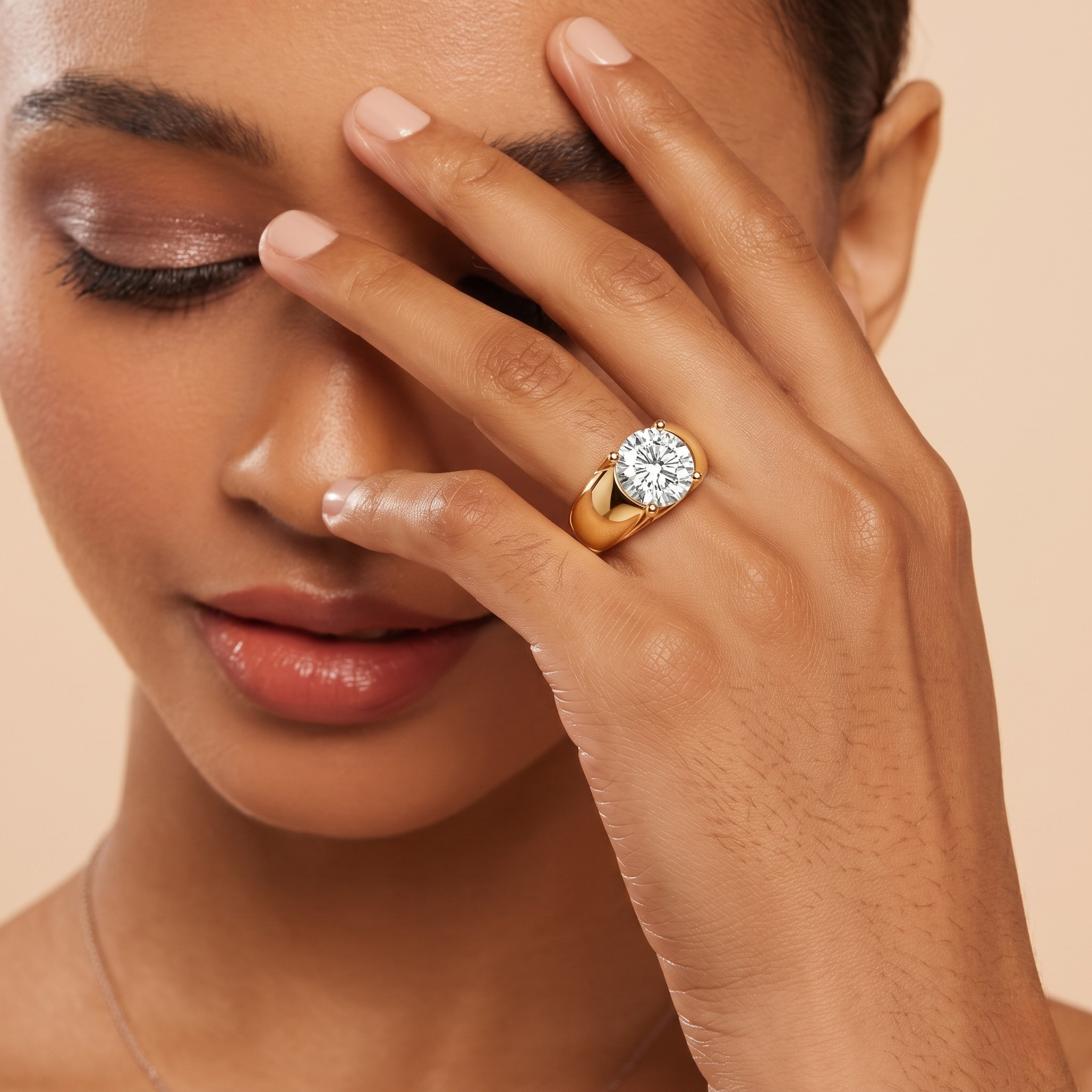 Woman wearing a gold ring with a diamond on a beige background