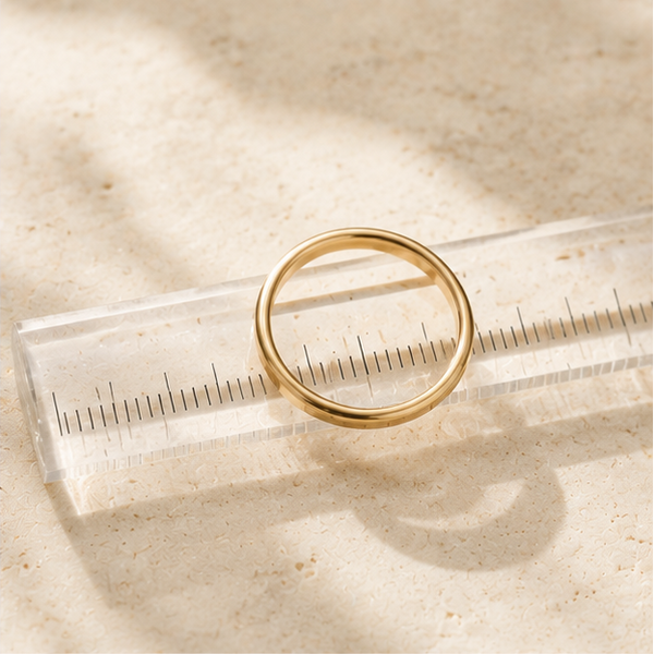 Collage of gold rings with measuring tools and jewelry display on a neutral background