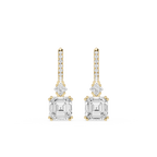 Gold and diamond earrings on a white background