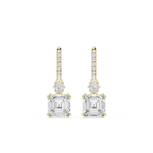 Gold and diamond earrings on a white background
