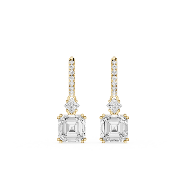 Gold and diamond earrings on a white background