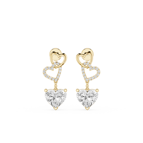 Heart-shaped earrings with gold and clear gemstones on a white background