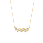 Gold necklace with clear stones on a white background