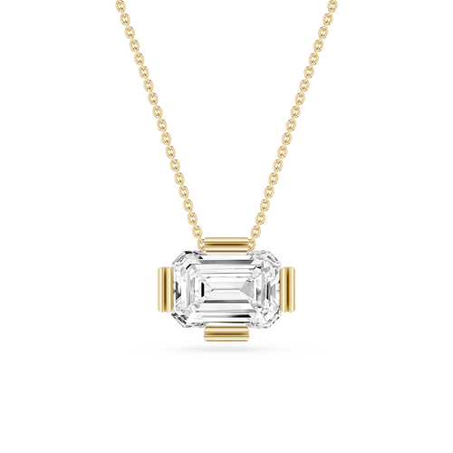 Gold necklace with a clear gemstone pendant on a white background