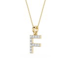 A gold initial pendant necklace featuring the letter 'F' paved with small clear stones, suspended from a delicate gold chain on a white background.