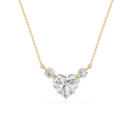 A yellow gold necklace featuring a heart-shaped diamond pendant with two smaller round diamonds on either side, set against a plain white background.