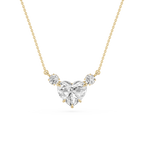 A yellow gold necklace featuring a heart-shaped diamond pendant with two smaller round diamonds on either side, set against a plain white background.