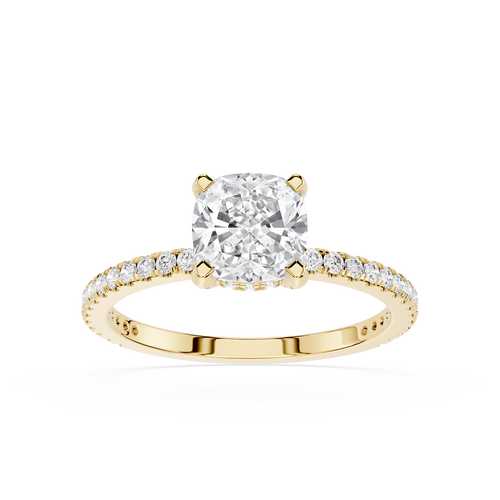 Gold ring with a large diamond and smaller diamonds on the band against a white background
