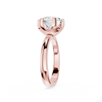 Rose gold ring with a clear gemstone on a white background