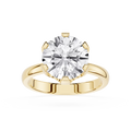 Gold ring with a large diamond on a white background