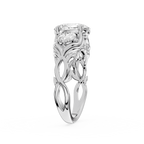 Silver ring with intricate design and central gemstone on a white background