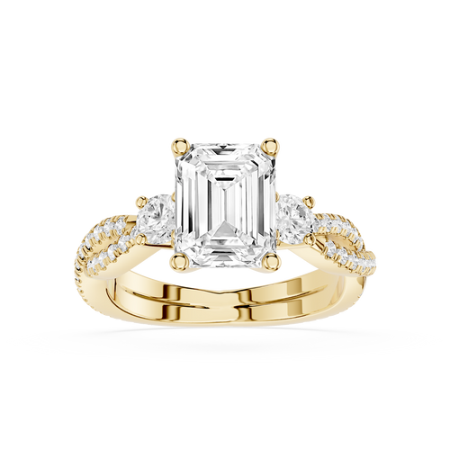Gold ring with a large emerald-cut diamond and smaller diamonds on a white background