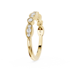 Gold ring with diamond accents on a white background