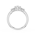 Diamond ring with a central gemstone and baguette-cut stones on a white background