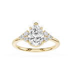 Gold ring with a pear-shaped diamond and smaller diamonds on a white background