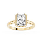 Gold ring with a large rectangular diamond on a white background