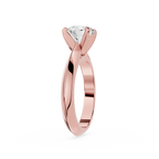 Rose gold ring with a diamond on a white background
