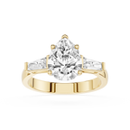 Gold ring with a large pear-shaped diamond on a white background