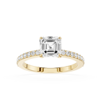 An emerald-cut diamond engagement ring in yellow gold, featuring a square center stone and a pavé-set diamond band, shown on a plain white background.