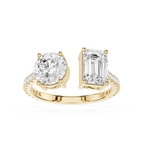A yellow gold split-shank ring featuring a round brilliant-cut diamond on one side and an emerald-cut diamond on the other, with small pavé diamonds along the band, set against a plain white background.