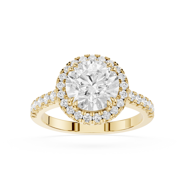 A yellow gold halo ring featuring a round-cut center diamond surrounded by a double halo of smaller diamonds, with a shank paved with small diamonds, shown on a white background.