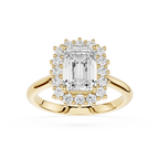 A yellow gold halo ring featuring a large emerald-cut center diamond surrounded by a double halo of smaller round diamonds, set on a polished gold band against a white background.