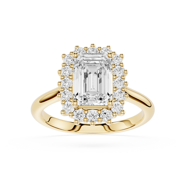 A yellow gold halo ring featuring a large emerald-cut center diamond surrounded by a double halo of smaller round diamonds, set on a polished gold band against a white background.
