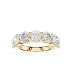 A yellow gold five-stone diamond ring with round brilliant-cut diamonds set in a row on a polished band, shown against a solid white background.