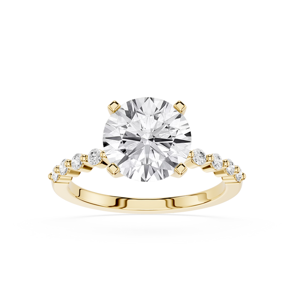 A yellow gold solitaire engagement ring featuring a round brilliant-cut diamond center stone and a pavé band with small round diamonds, set against a plain white background.